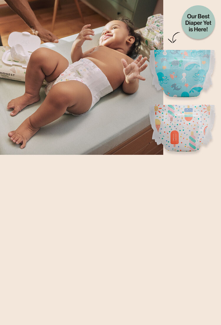 Toddler laying on diaper changing station. 2 summer seasonal diaper prints on display, with badge "Our Best Diaper Yet Is Here!"