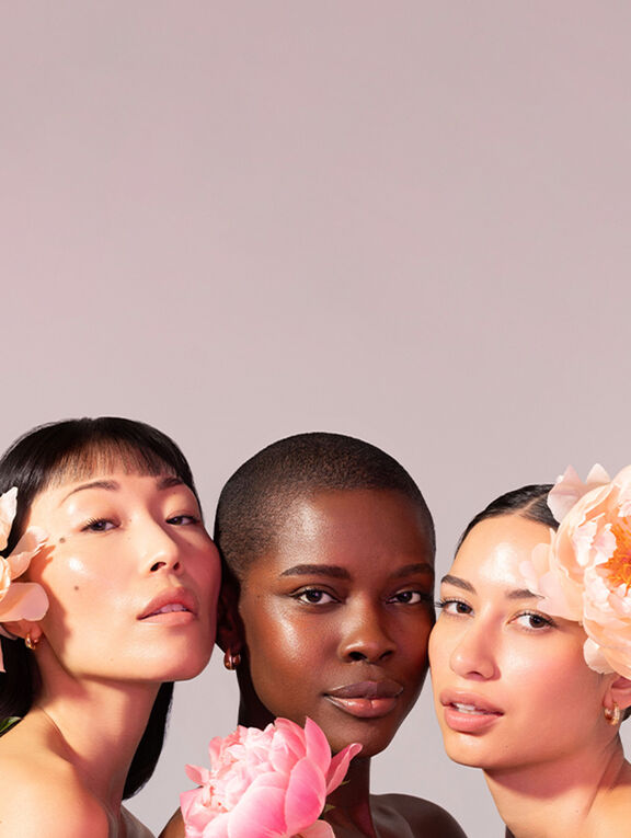 3 women with pink floral hair accessories