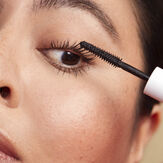 Woman putting on honest mascara