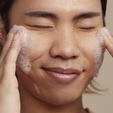 Model washing face with gentle gel cleanser