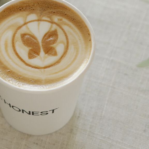 Latte with foam art in the shape of the Honest Company logo Latte with foam art in the shape of the Honest Company logo