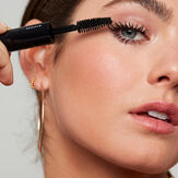 Woman using Honest Extra Volume Mascara