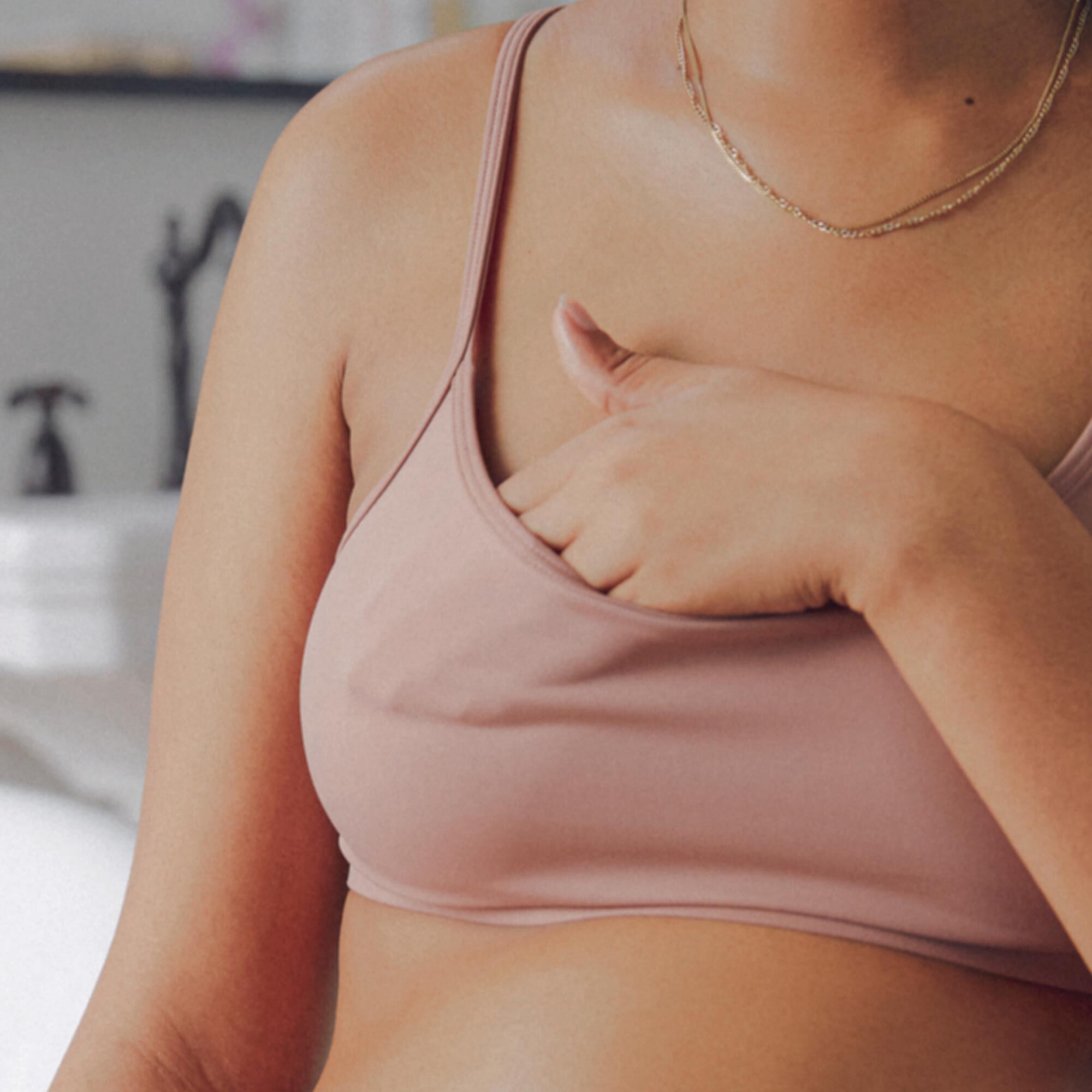 Pregnant mom applying nipple cream