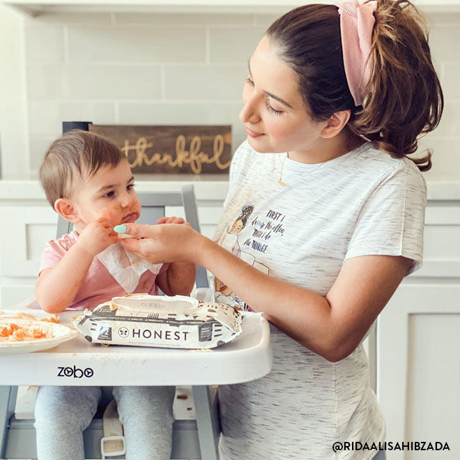 Mom using honest wipes with baby