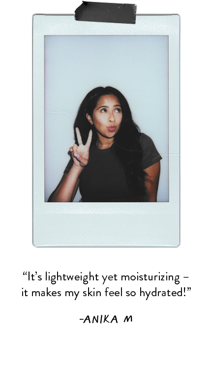 Polaroid photo of woman wearing black t-shirt and posing with the peace sign