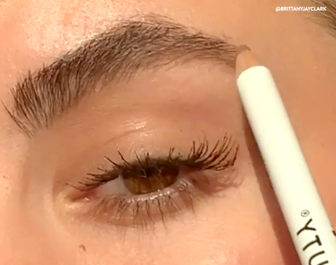 Woman applying Eyebrow Pencil