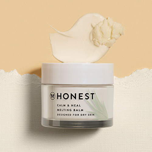 Jar of Honest Calm + Heal Melting Balm on a canvas background with product smear