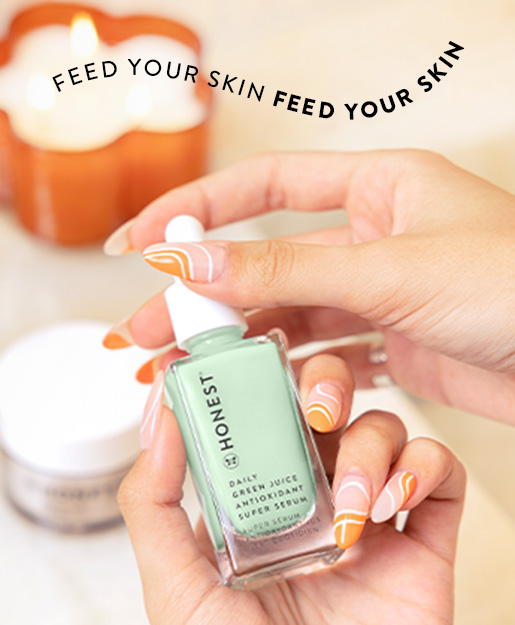 Daily Green Juice Serum being held on a bathroom counter